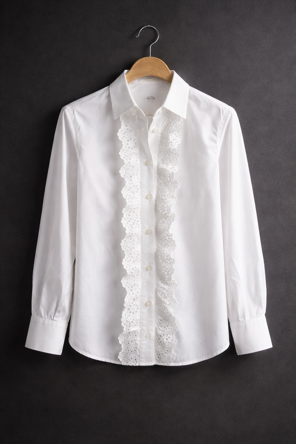 White long sleeve blouse with lace trim detail and button front on hanger
