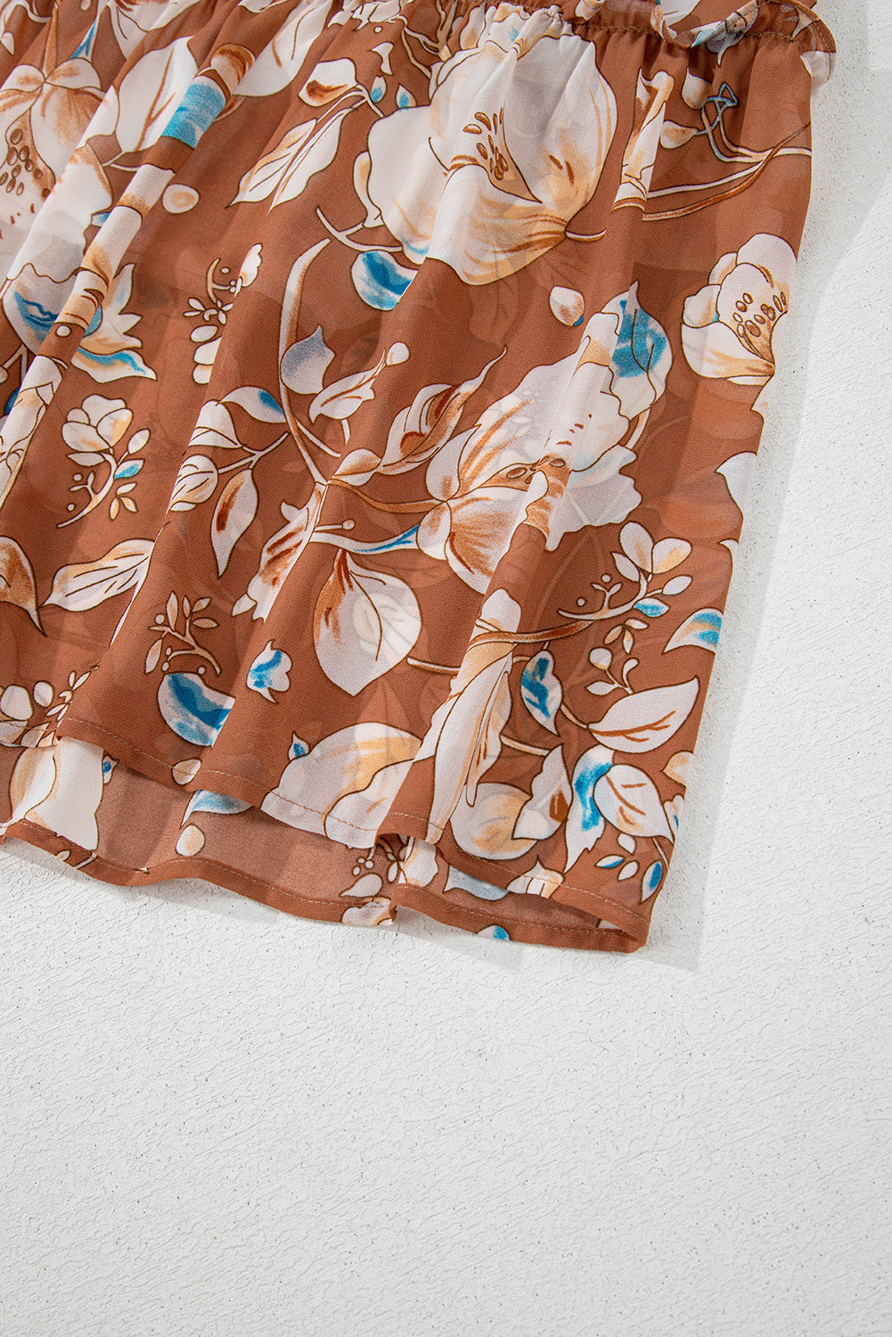 Brown floral skirt with white and blue flower print, lightweight fabric, elastic waistband