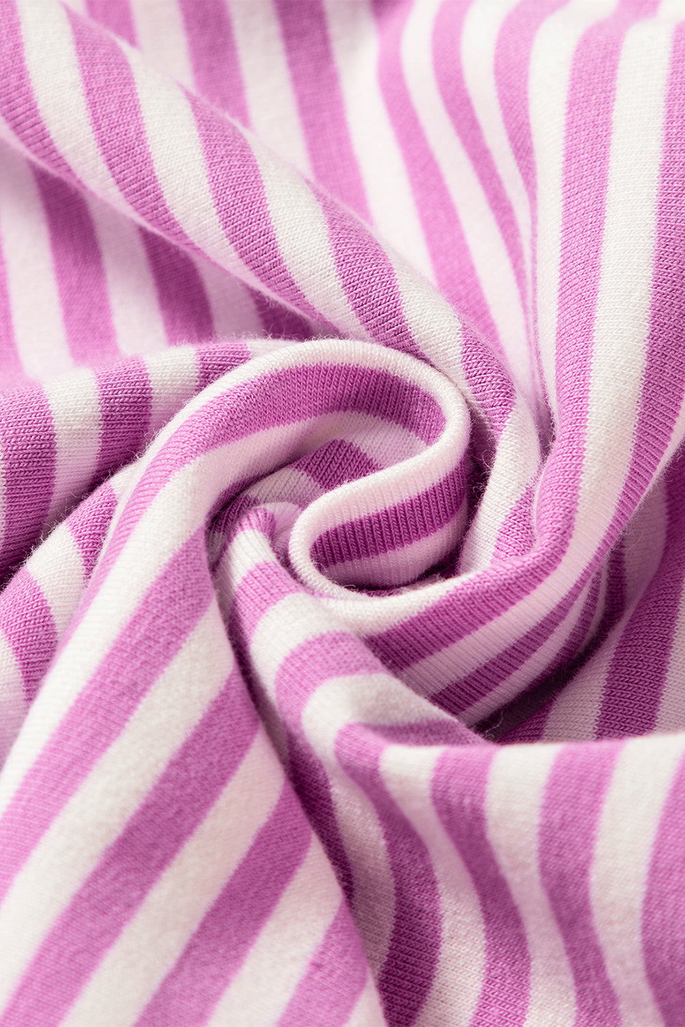 Close-up of soft pink and white striped fabric, twisted, textured knit textile