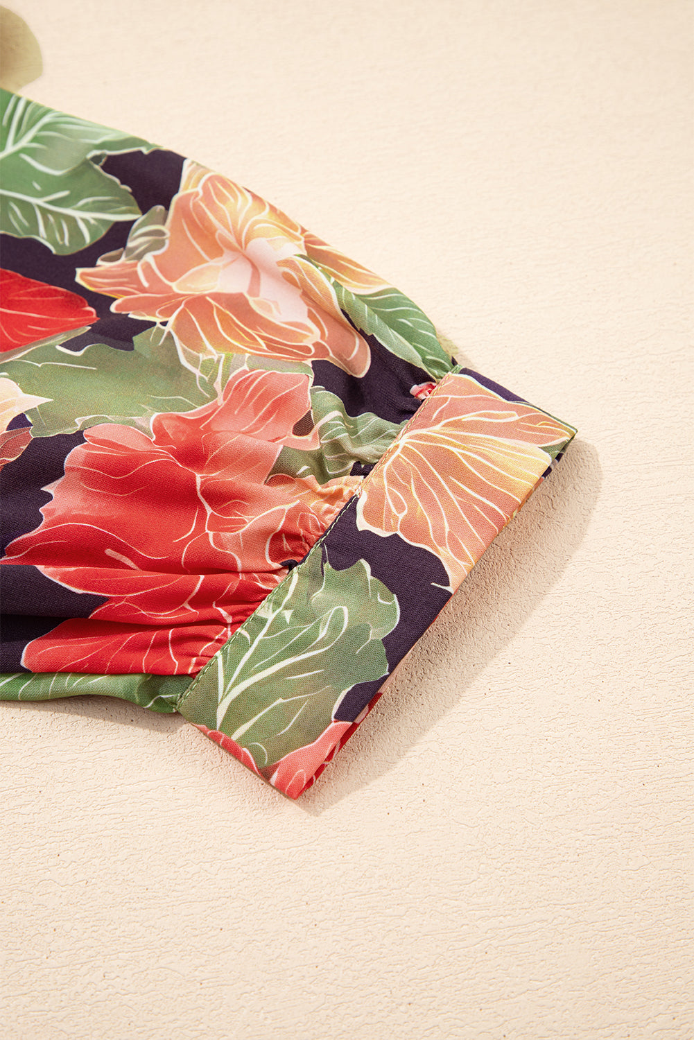 Close-up of colorful floral sleeve cuff on lightweight women's blouse
