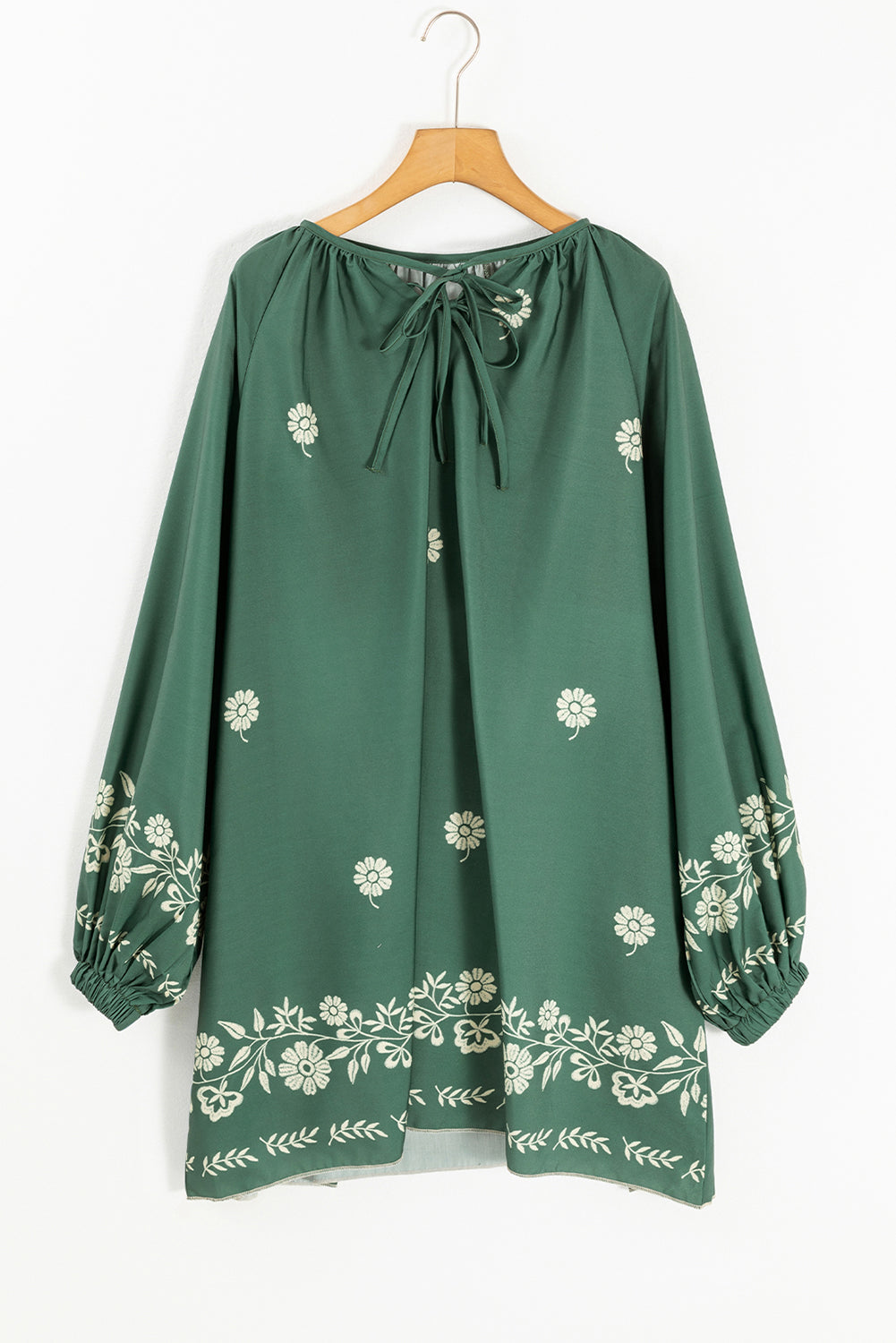 Green long-sleeve tunic with white floral embroidery and tie neckline, boho style