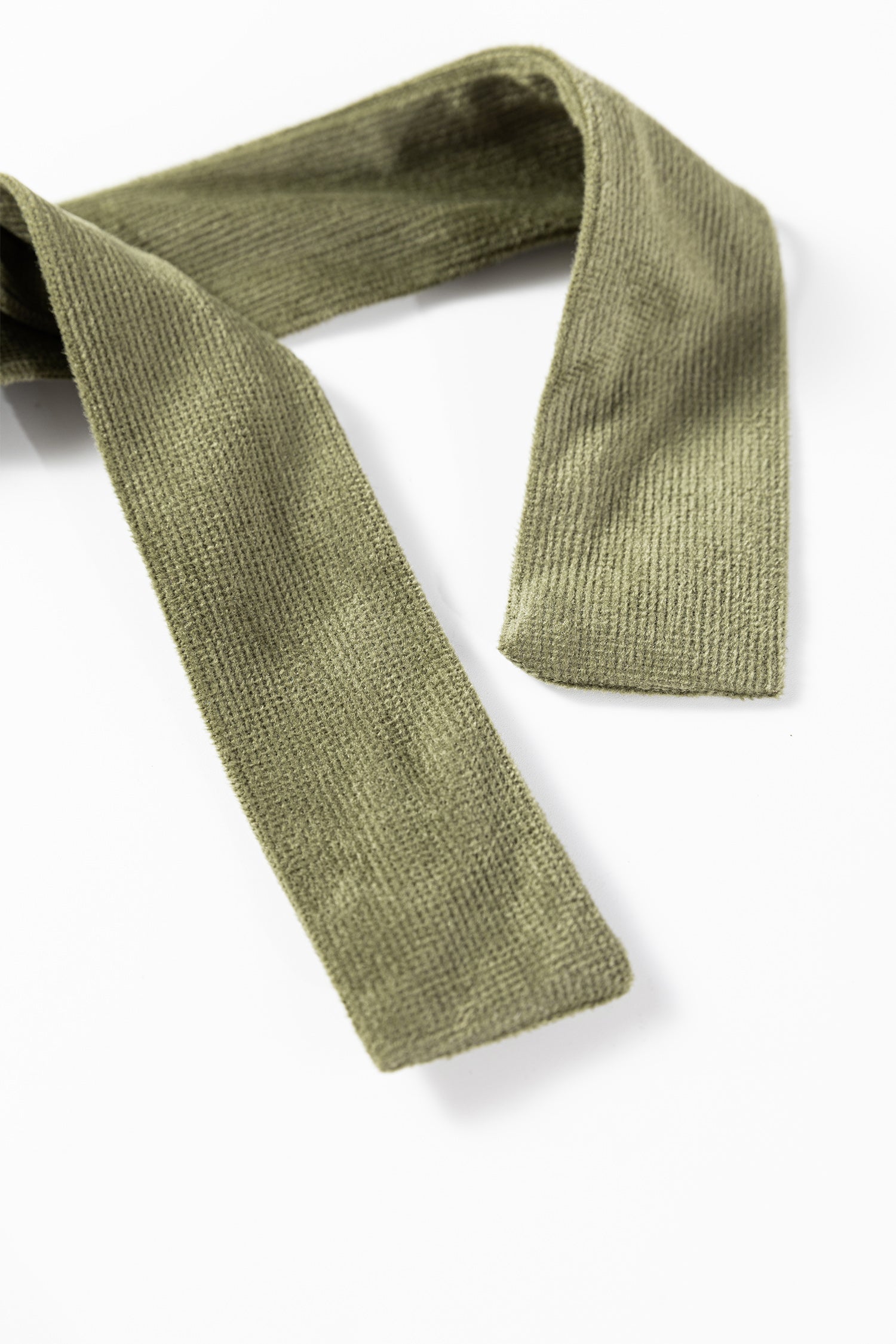 Olive green ribbed fabric belt or sash on a white background