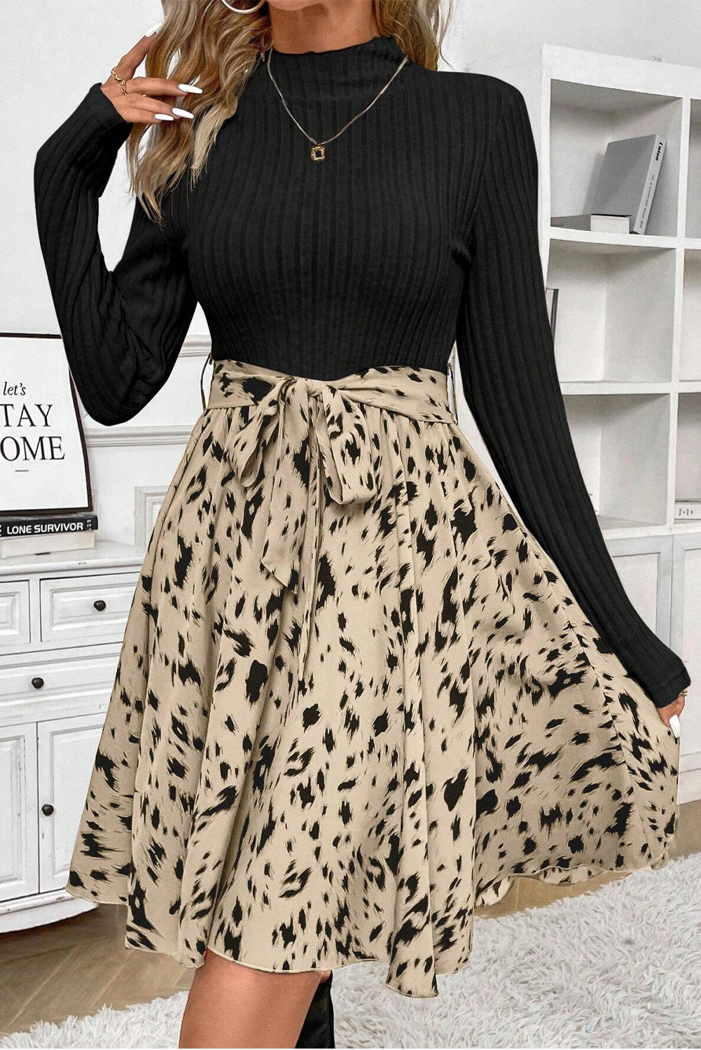 Long sleeve black ribbed top with beige animal print skirt and bow belt, casual dress