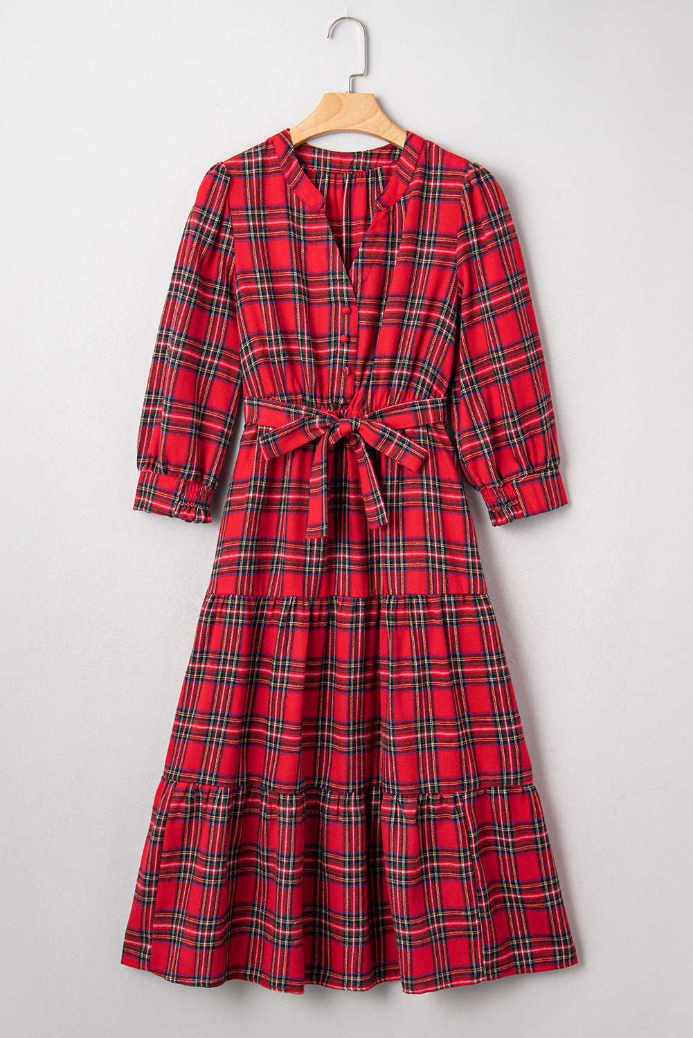 Red plaid long-sleeve midi dress with a waist tie and button front on hanger