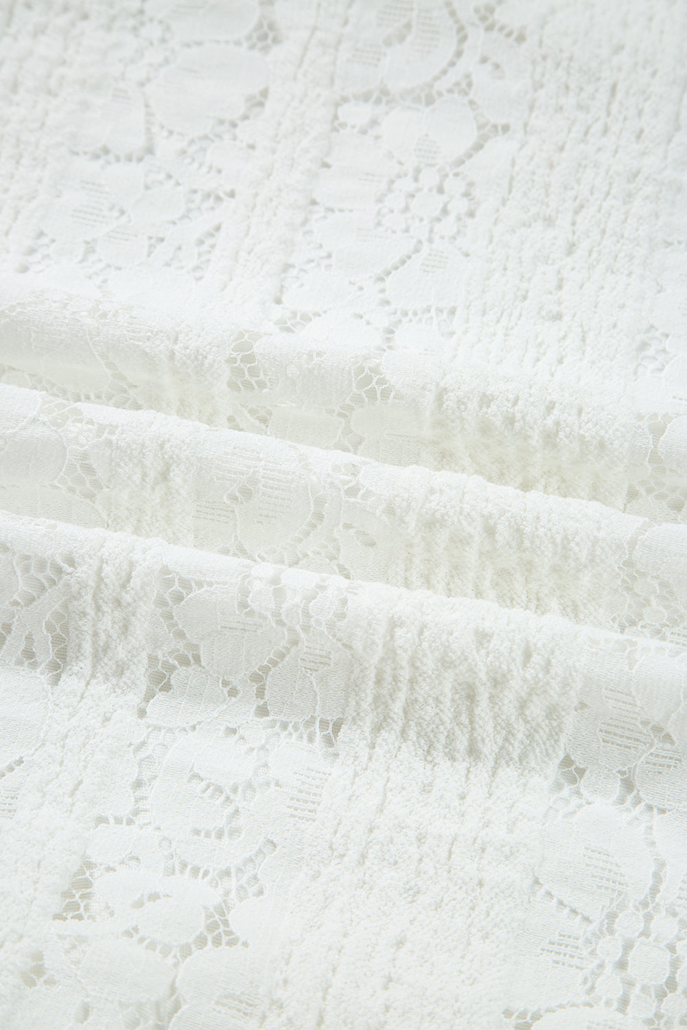 Close-up of white floral lace fabric texture, delicate and lightweight textile pattern