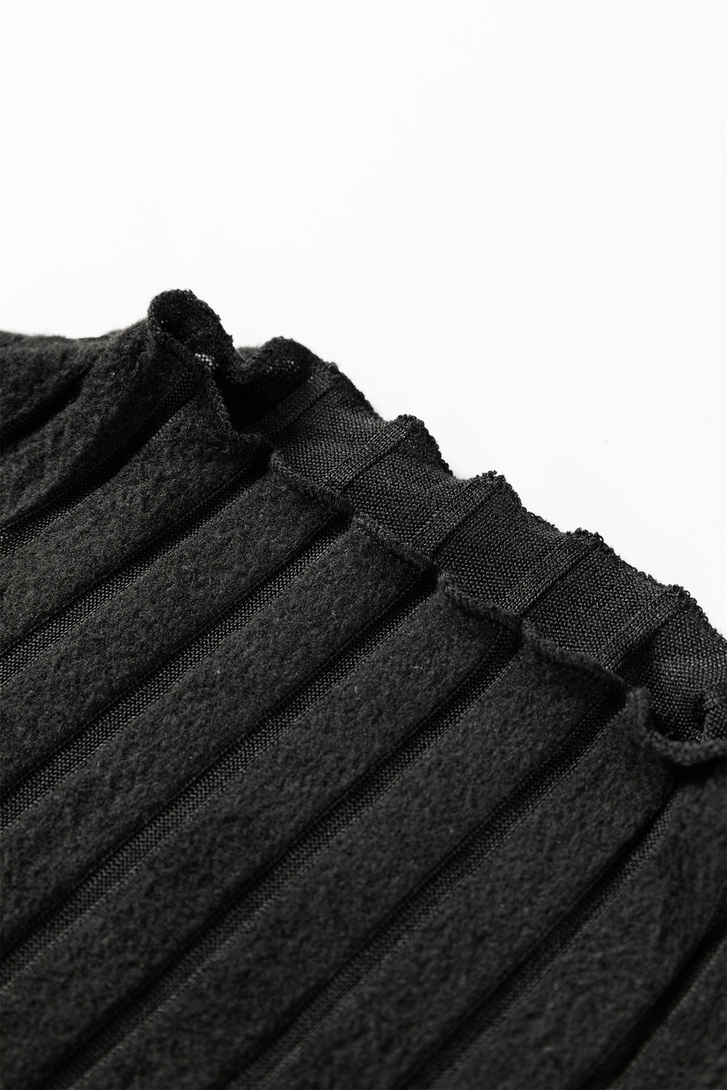 Close-up of black ribbed knit fabric with textured vertical lines