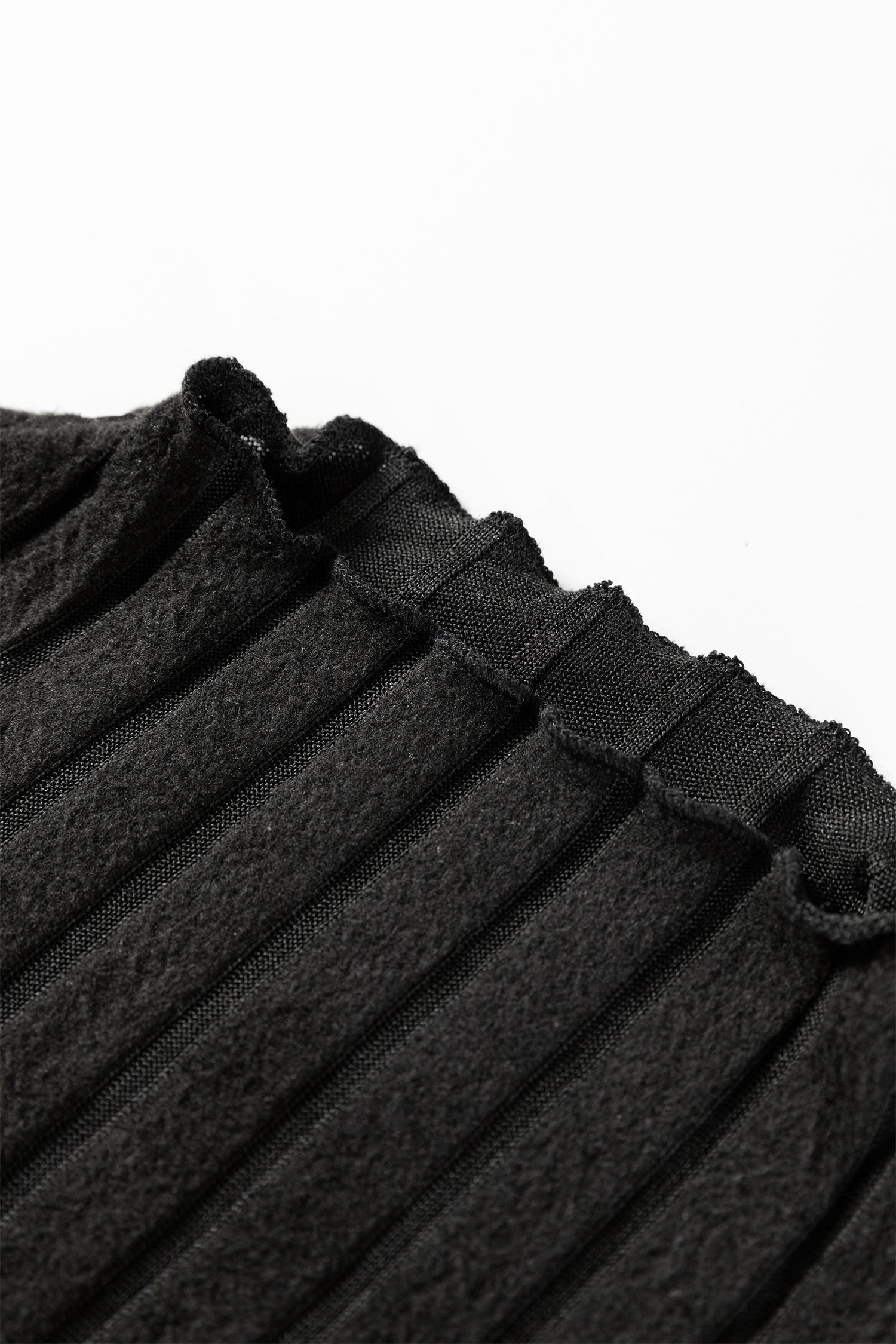 Close-up of black ribbed knit fabric with textured vertical lines