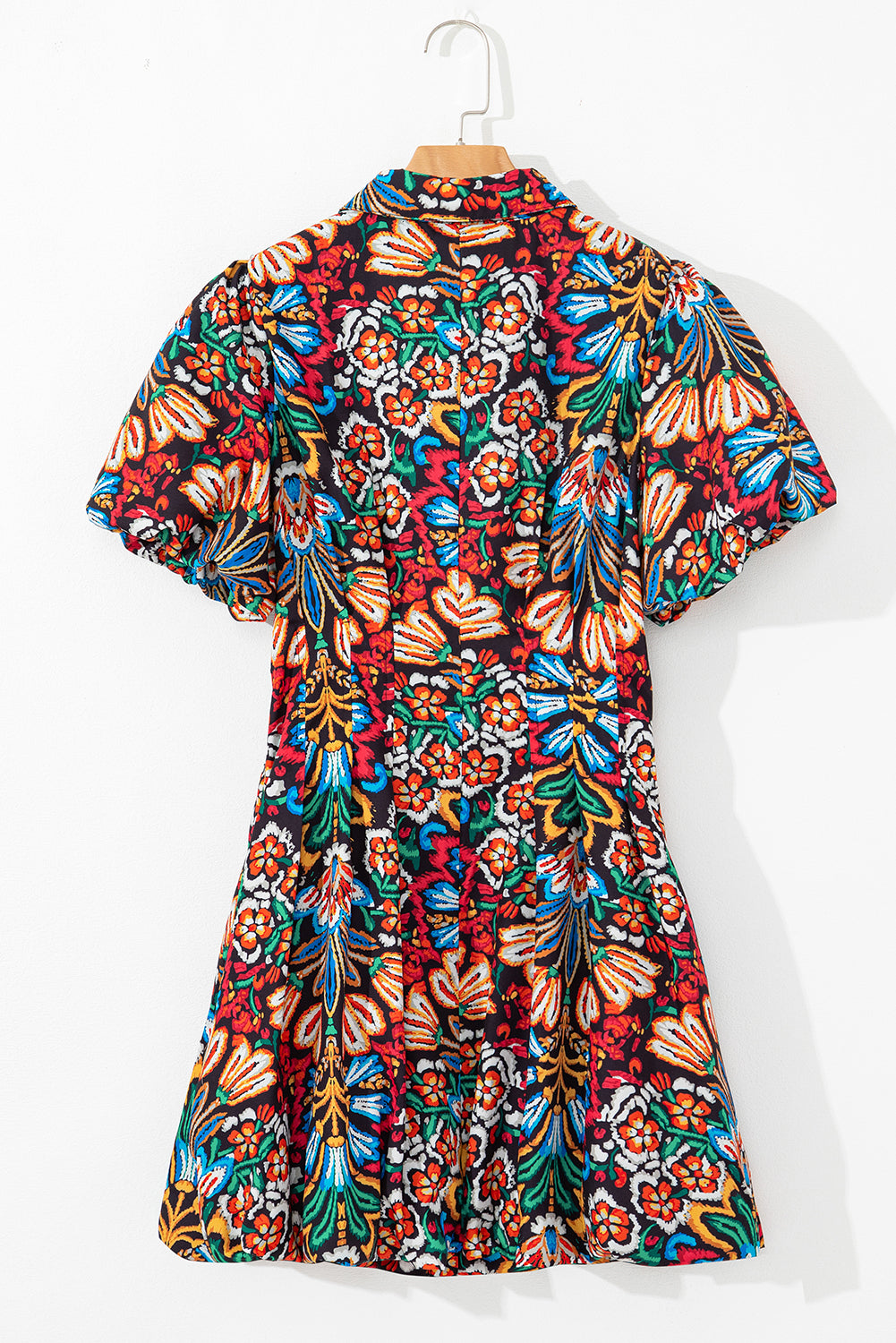 Colorful short-sleeve floral dress with bold red, blue, yellow, and green patterns