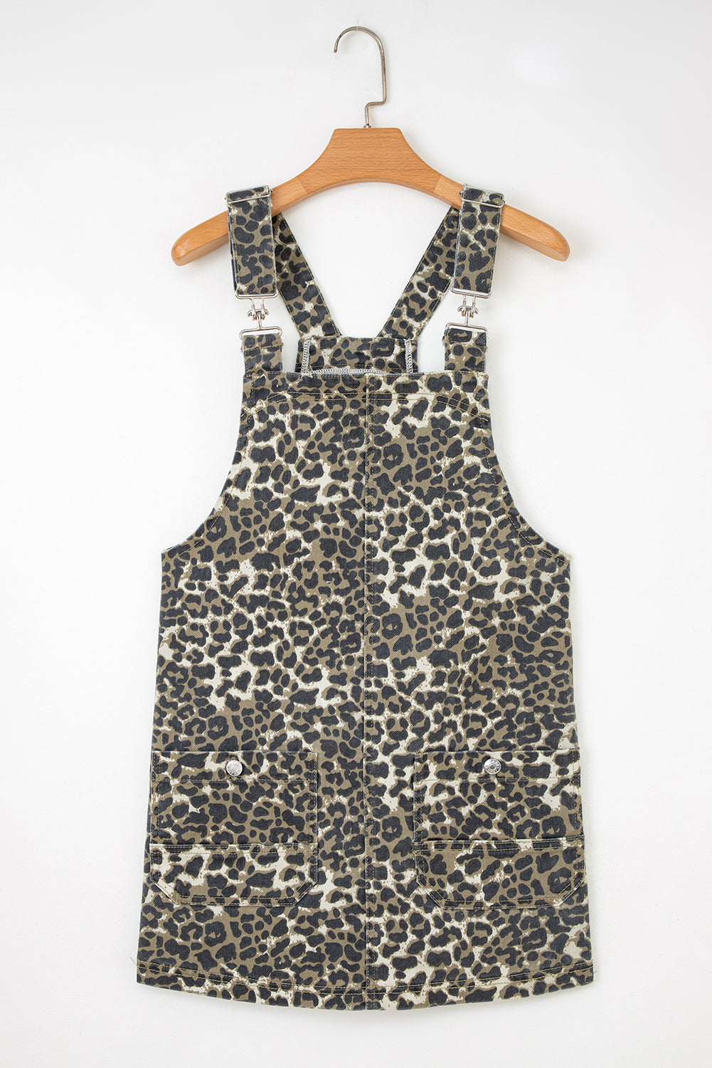 Leopard print overall dress with front pockets and adjustable straps on hanger