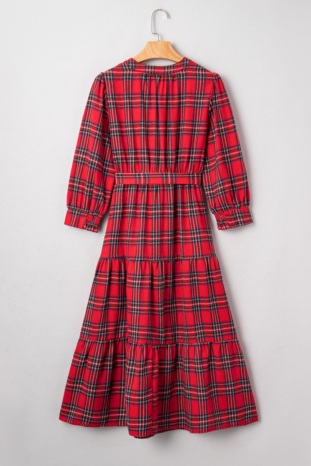 Red plaid long-sleeve midi dress with belt and ruffled skirt on hanger