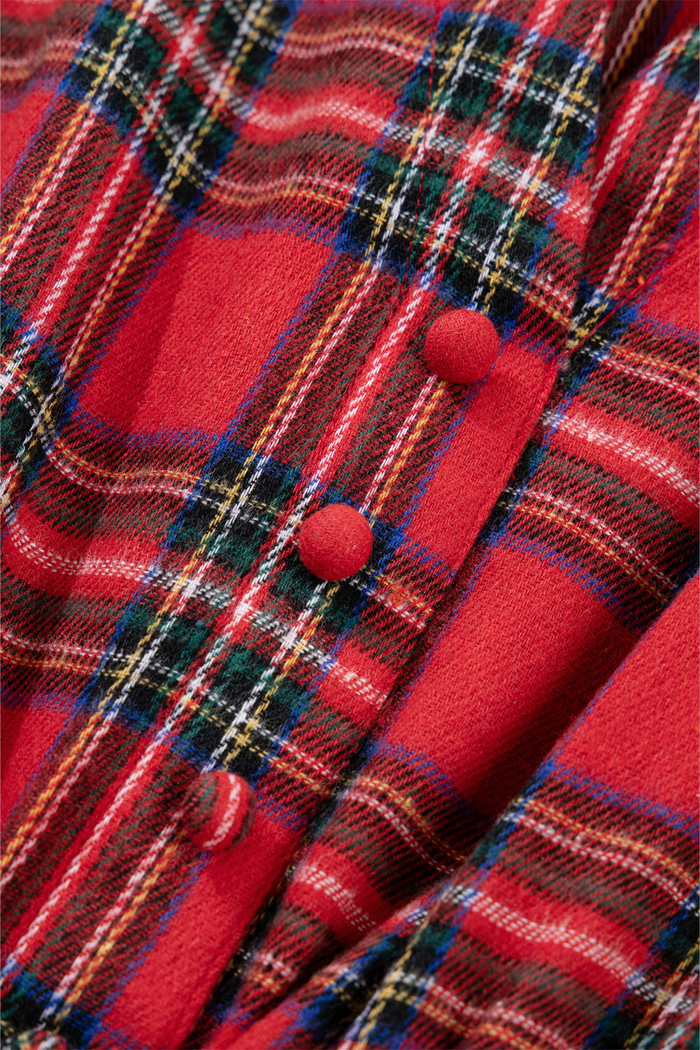 Red plaid fabric with round fabric buttons, featuring green, white, and yellow stripes.