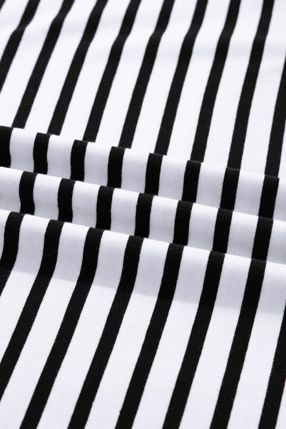 Close-up of black and white vertical striped fabric, soft cotton textile texture