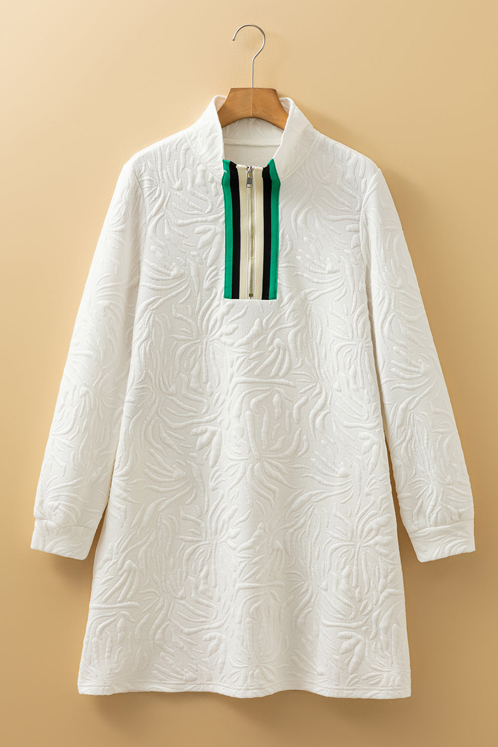 Textured white long-sleeve dress with green striped zip collar on a hanger.
