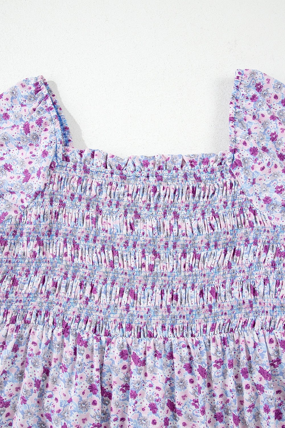 Smocked floral dress with puff sleeves in purple and blue watercolor print