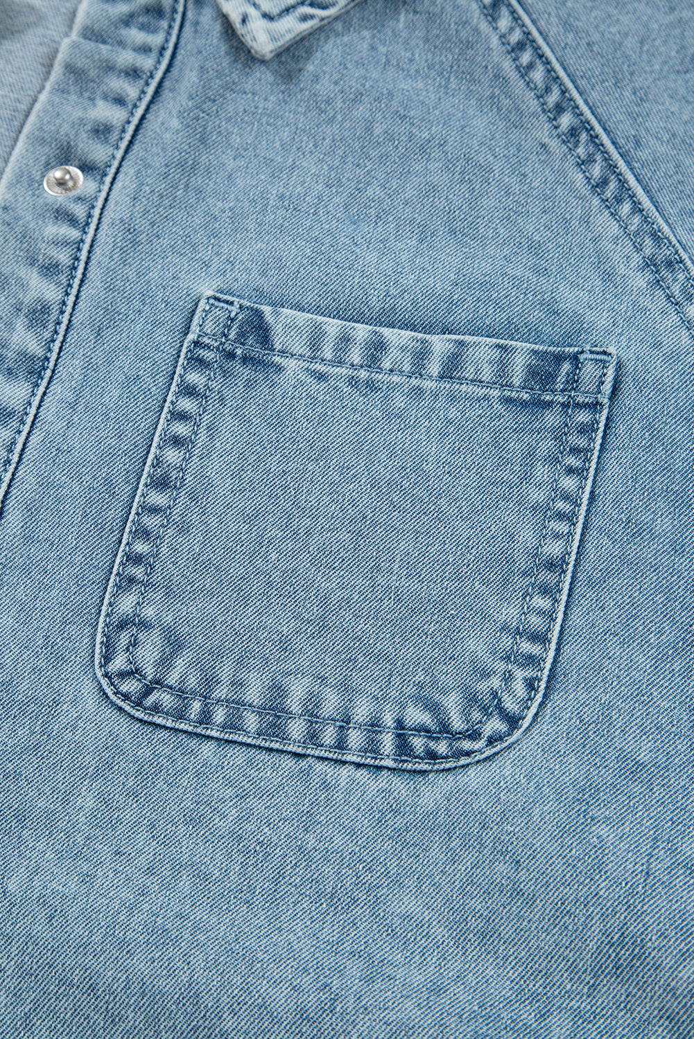 Light blue denim shirt with chest pocket and visible stitching details