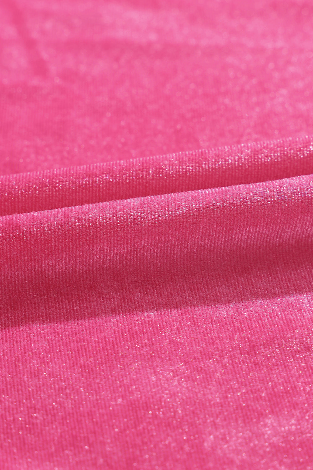 Close-up of soft pink ribbed fabric with subtle shimmer texture