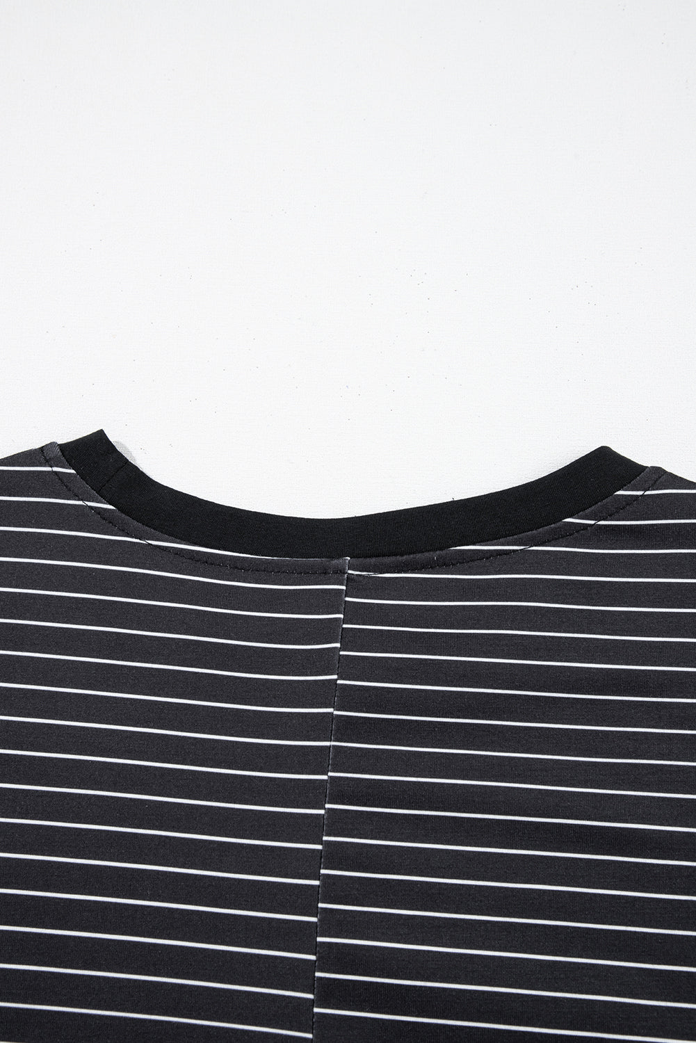Close-up of black and white striped shirt neckline with contrast collar