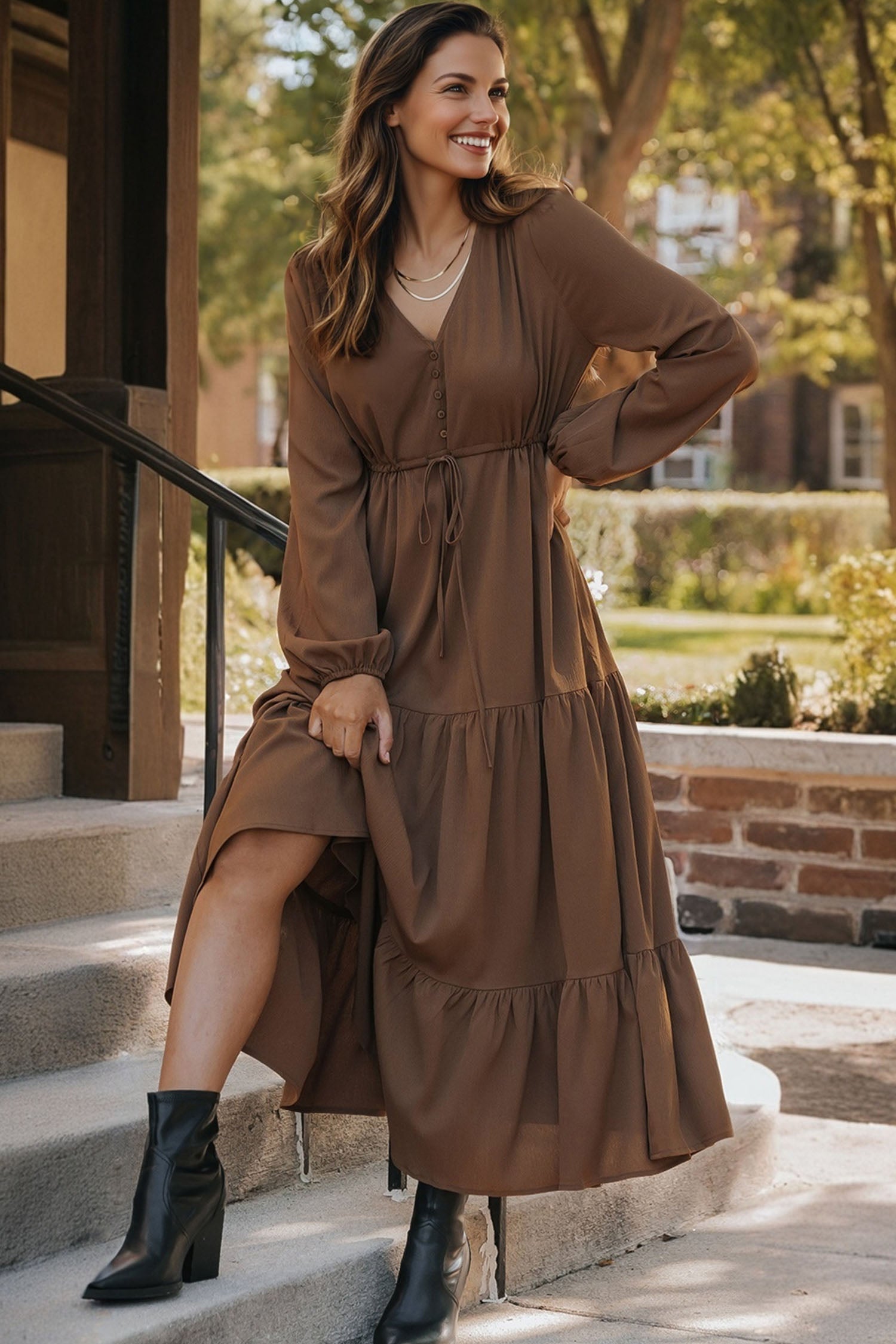 Woman in brown long-sleeve midi dress with buttons and black ankle boots outdoors