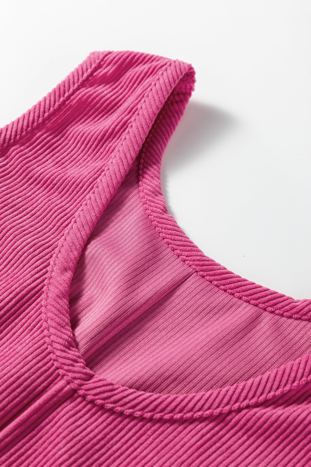 Close-up of ribbed pink tank top neckline in soft textured fabric