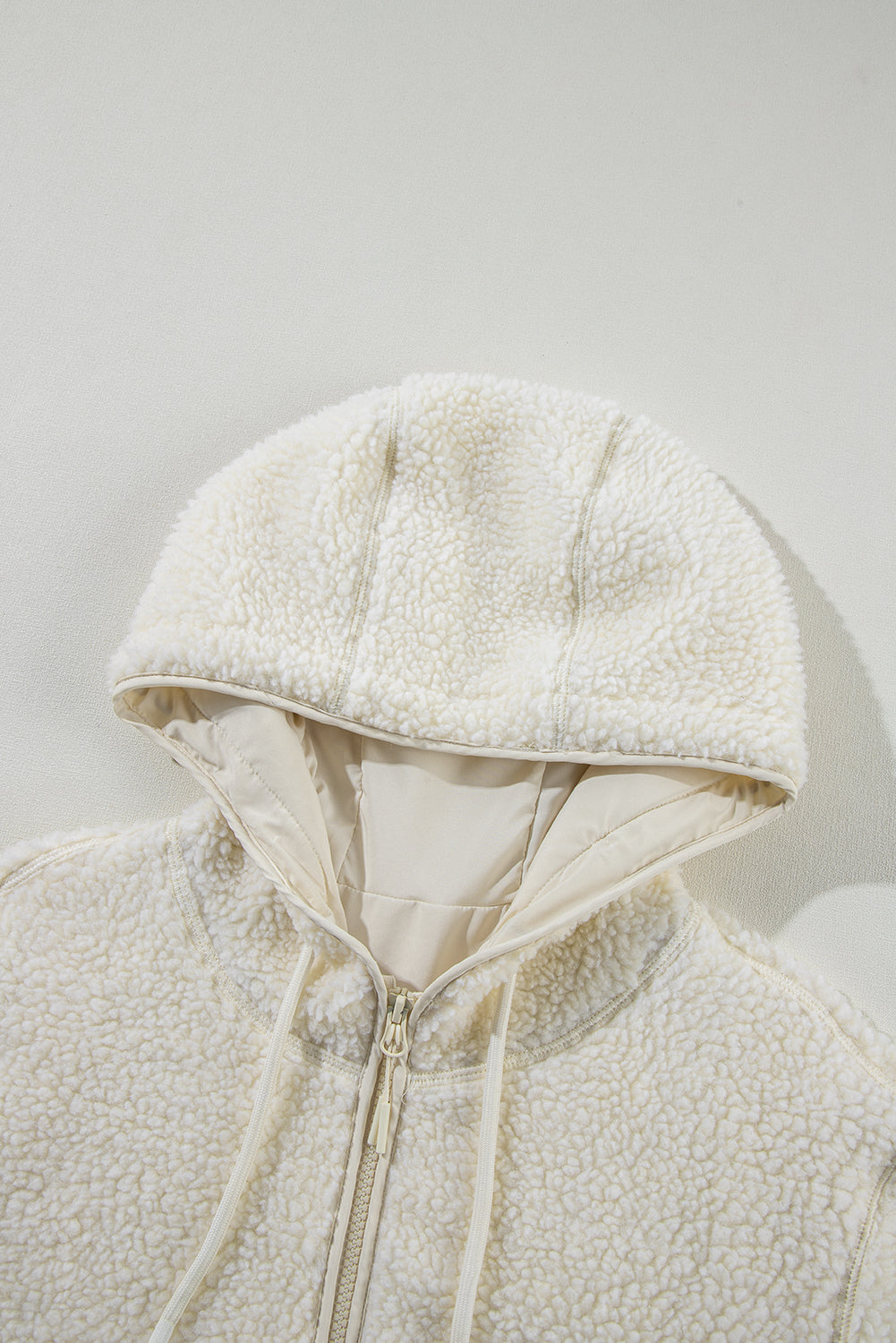 Fluffy light beige jacket with hood 