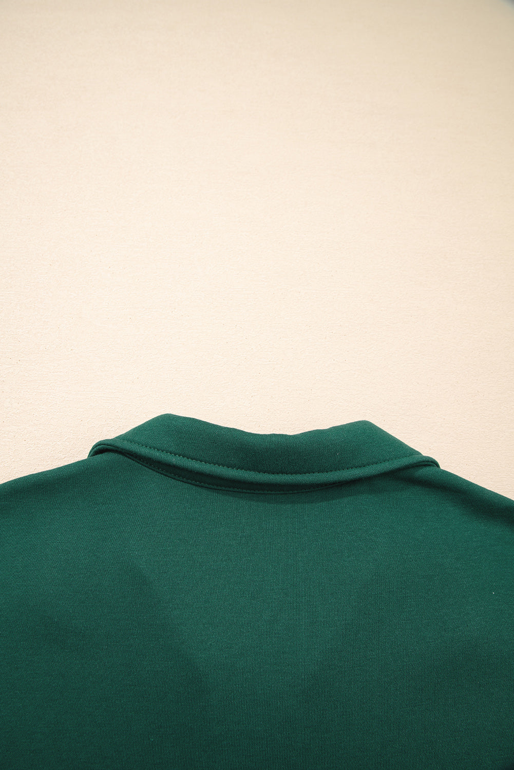 Back view of green polo shirt collar on light background