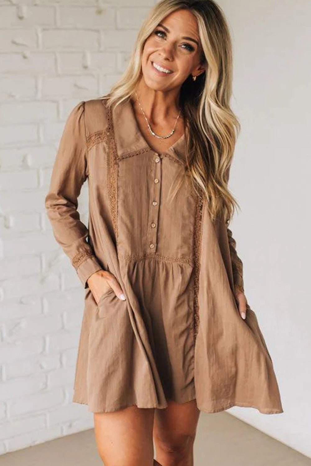 Woman in a light brown long sleeve button-front mini dress with pockets, casual fashion
