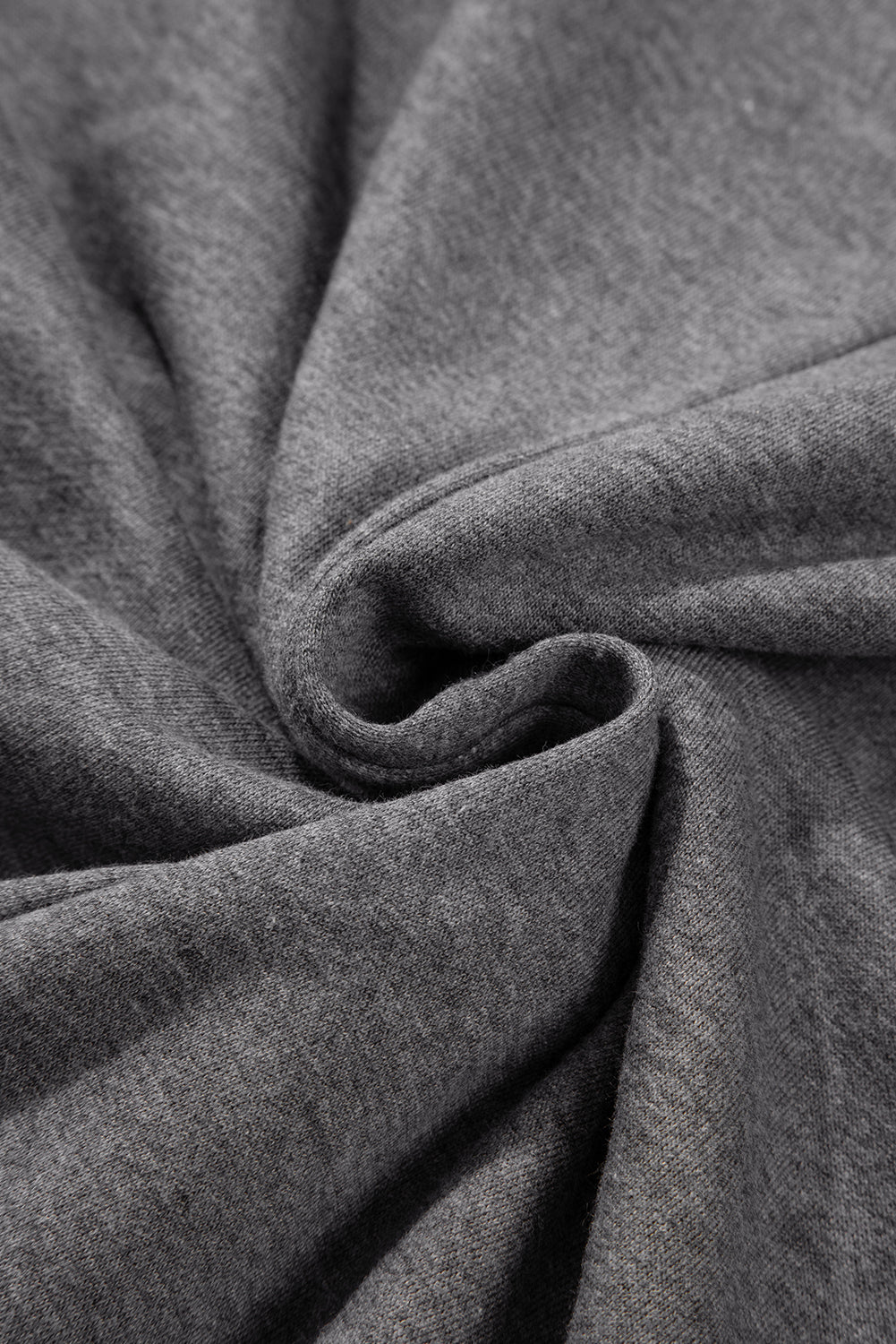 Close-up of soft grey fabric texture with subtle folds