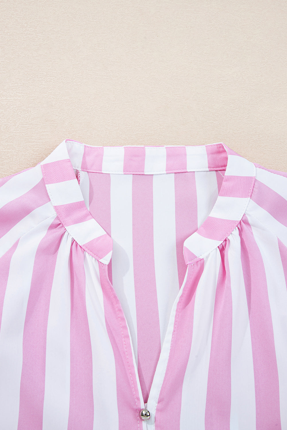 Pink and white vertical striped blouse with v-neck and gathered shoulders