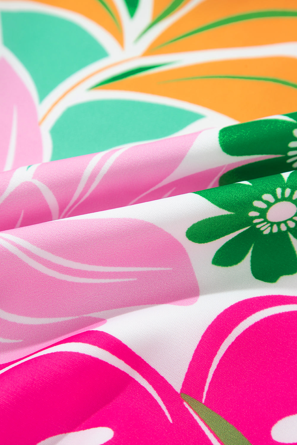 Colorful floral fabric with pink, green, and orange abstract flower patterns