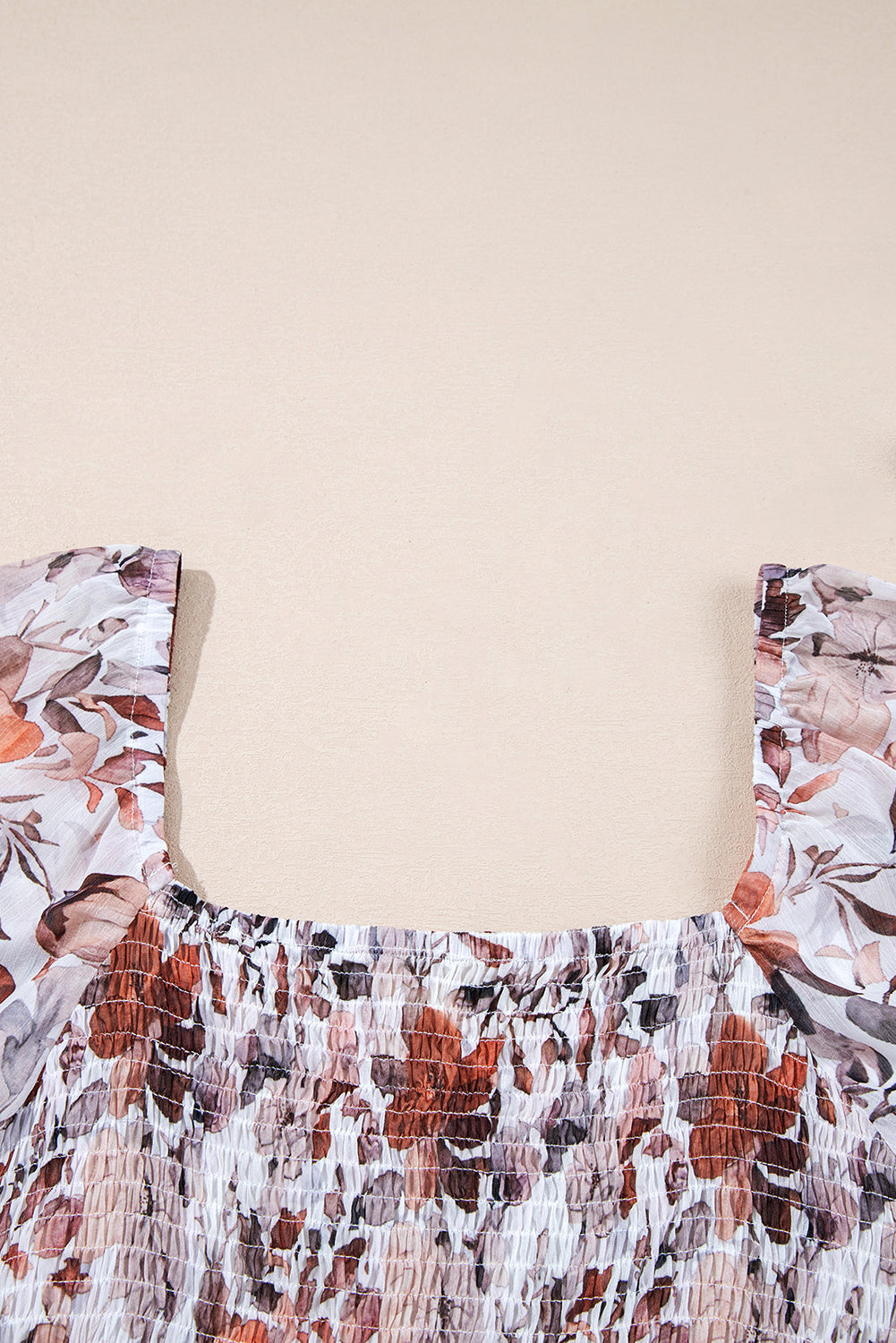 Close-up of a floral smocked top with square neckline and ruffled straps