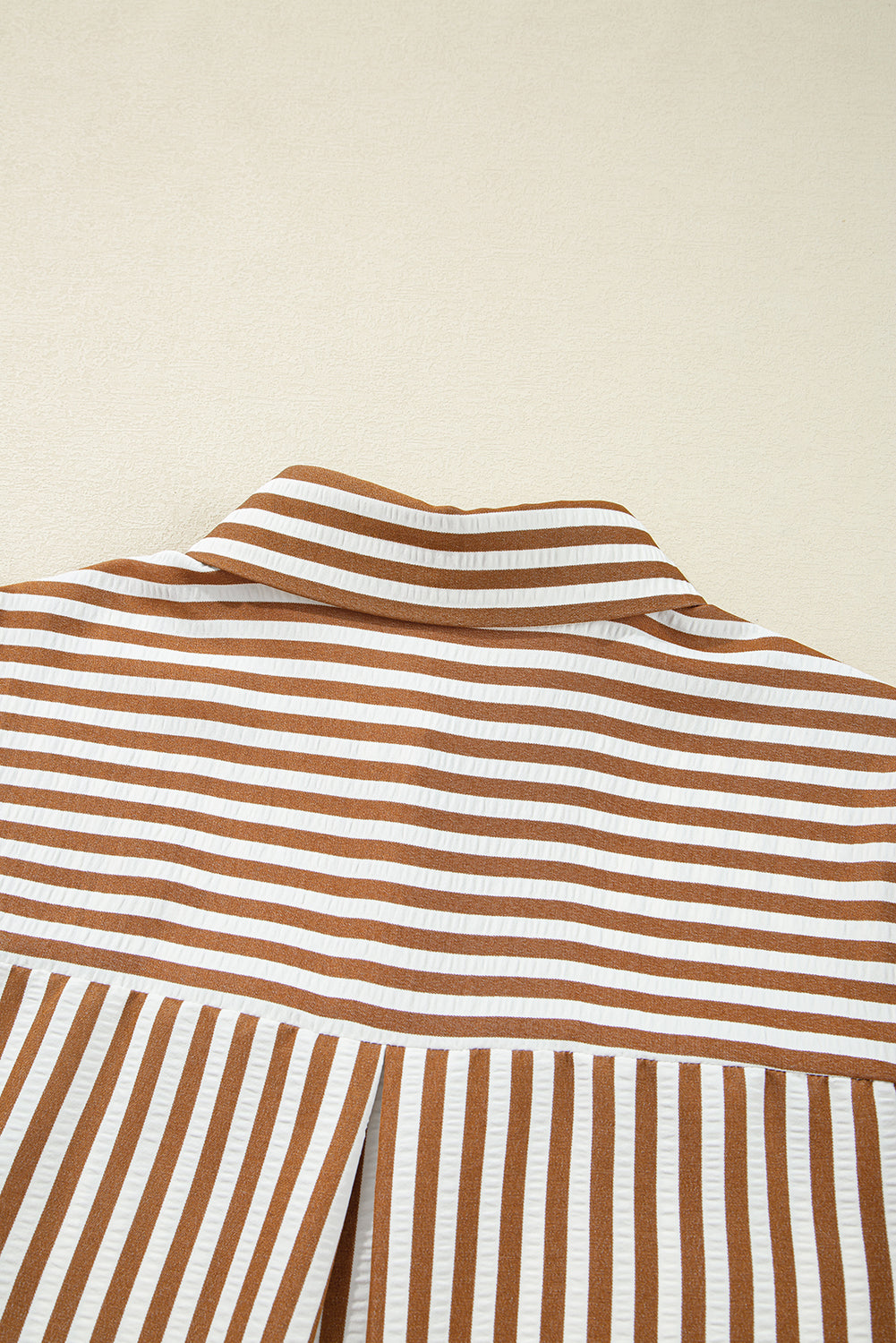 Close-up of brown and white striped shirt collar and back detail