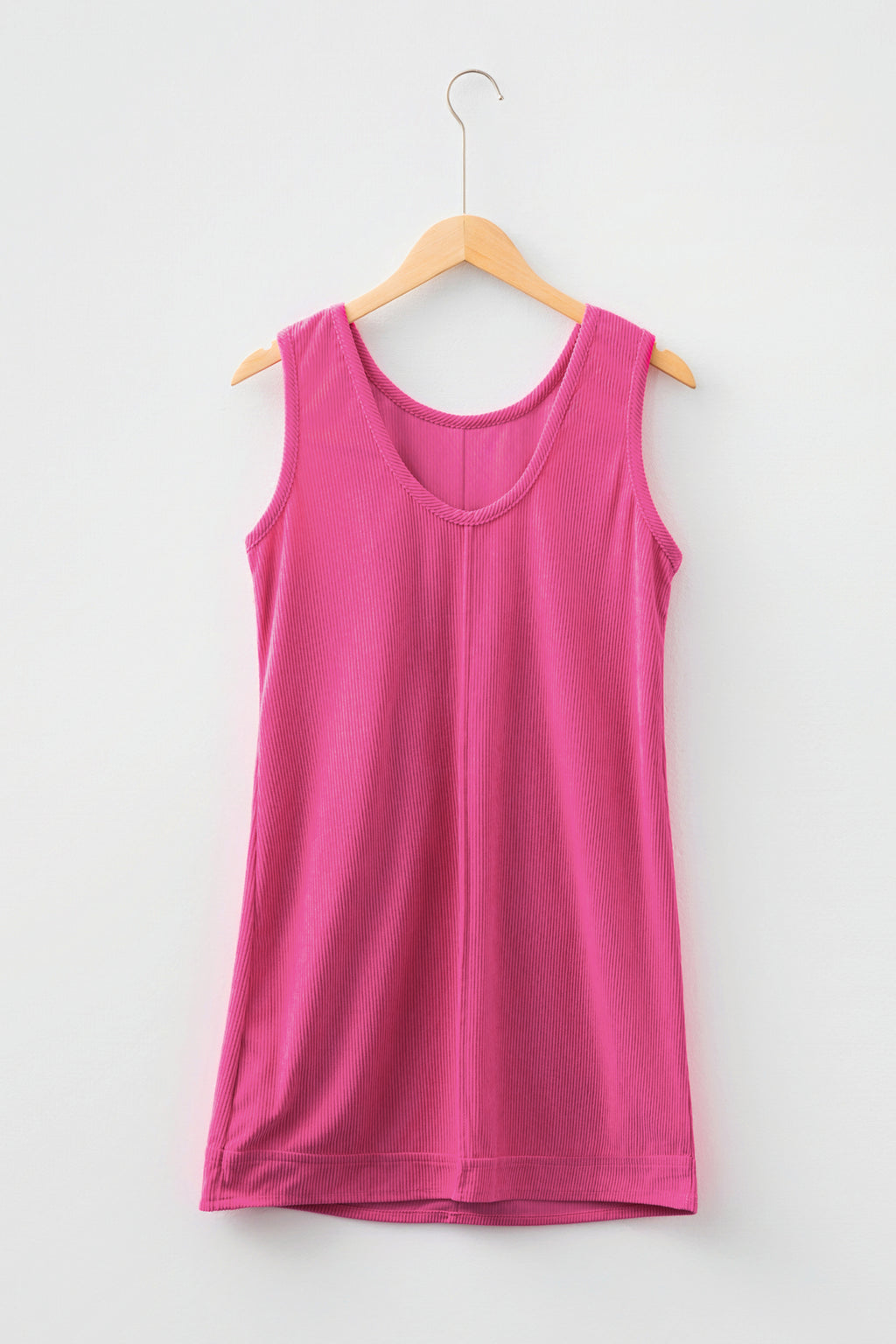 Sleeveless ribbed pink tank top on wooden hanger against white background