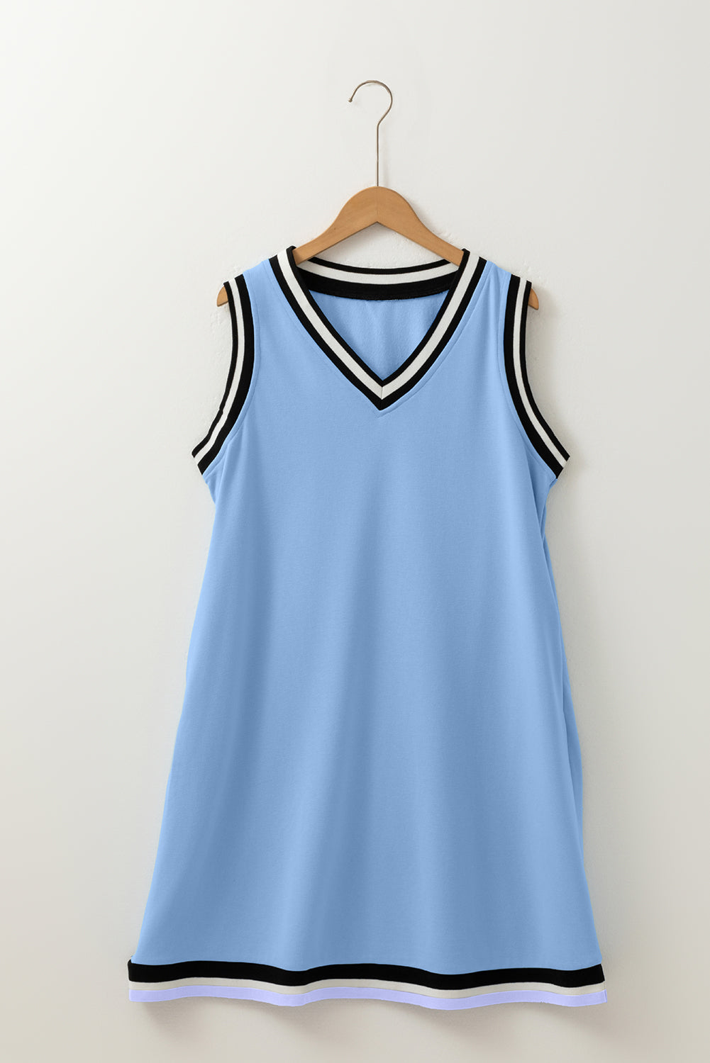 Sleeveless light blue dress with black and white striped trim, V-neck, on hanger