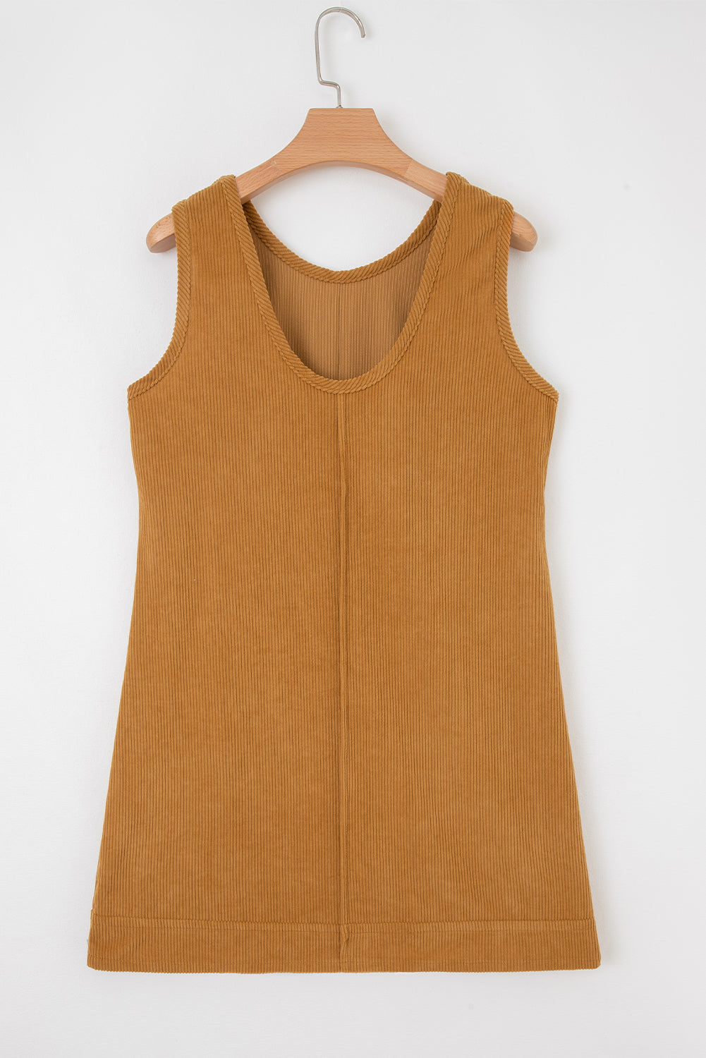 Sleeveless ribbed corduroy dress in camel brown, displayed on wooden hanger against white background