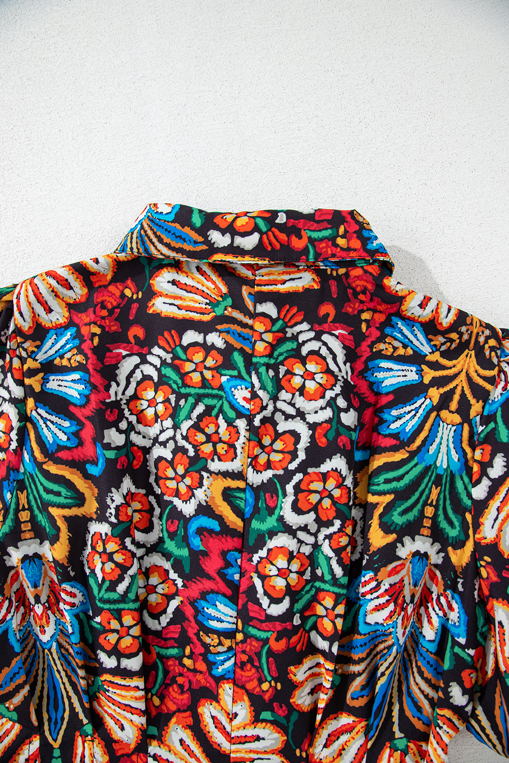 Colorful floral print shirt collar with vibrant red, blue, green, and orange patterns