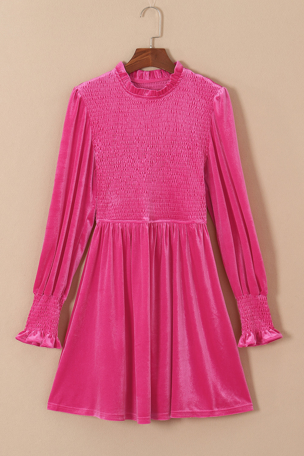 Pink velvet dress with long smocked sleeves and a ruffled high neckline