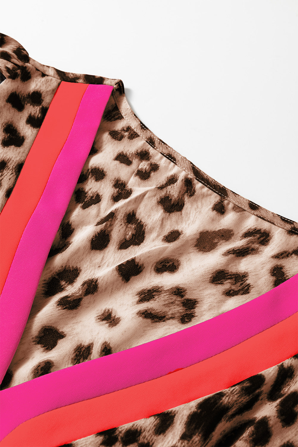 Leopard print satin fabric with pink and orange stripes, close-up detail