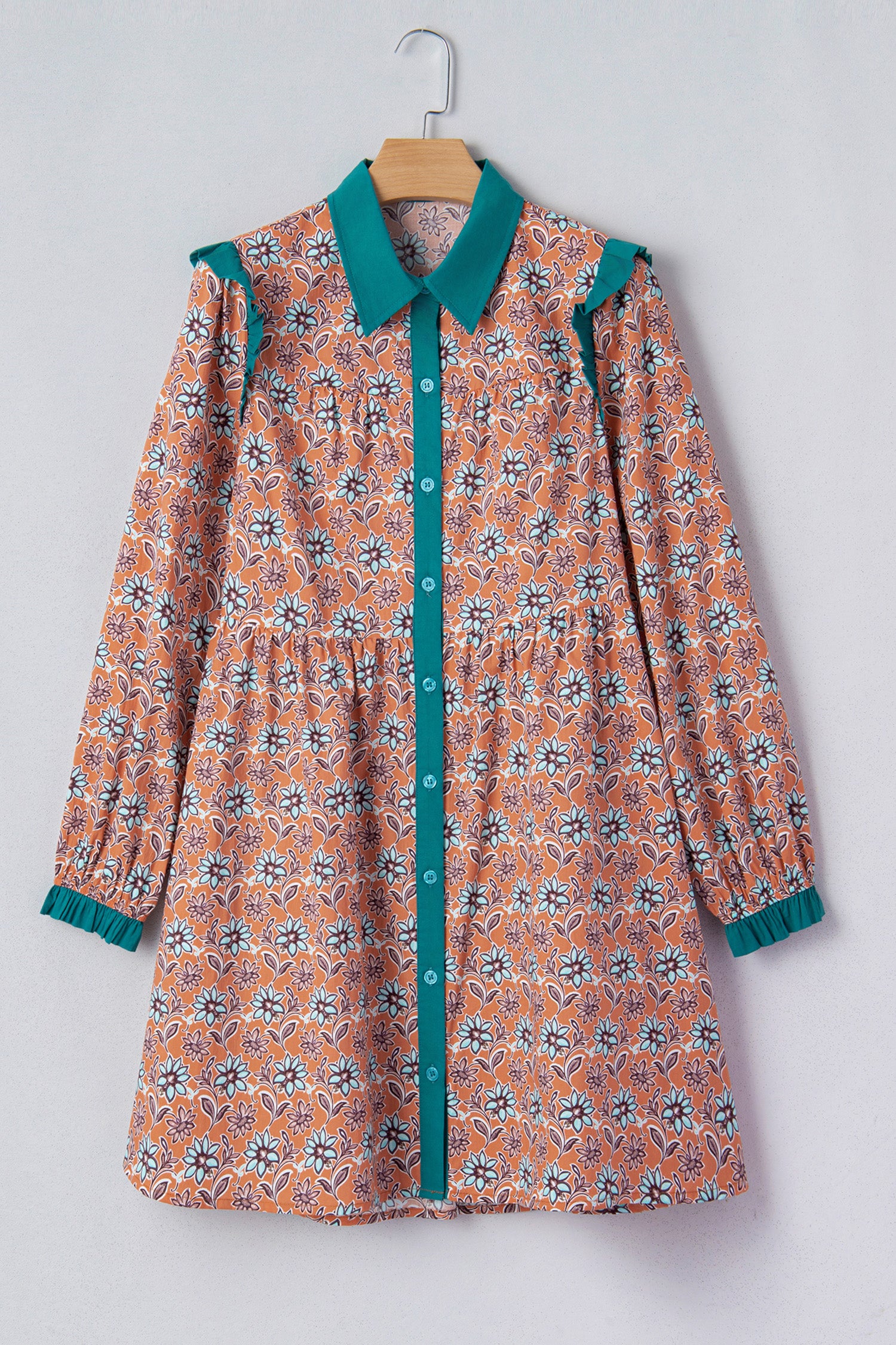 Long sleeve floral blouse with orange and teal pattern, teal collar and button placket