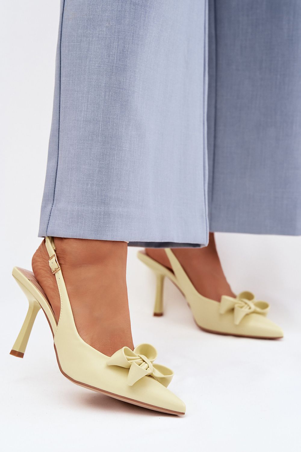 светложълти дамски обувки с ток и панделка - изглед върху модел