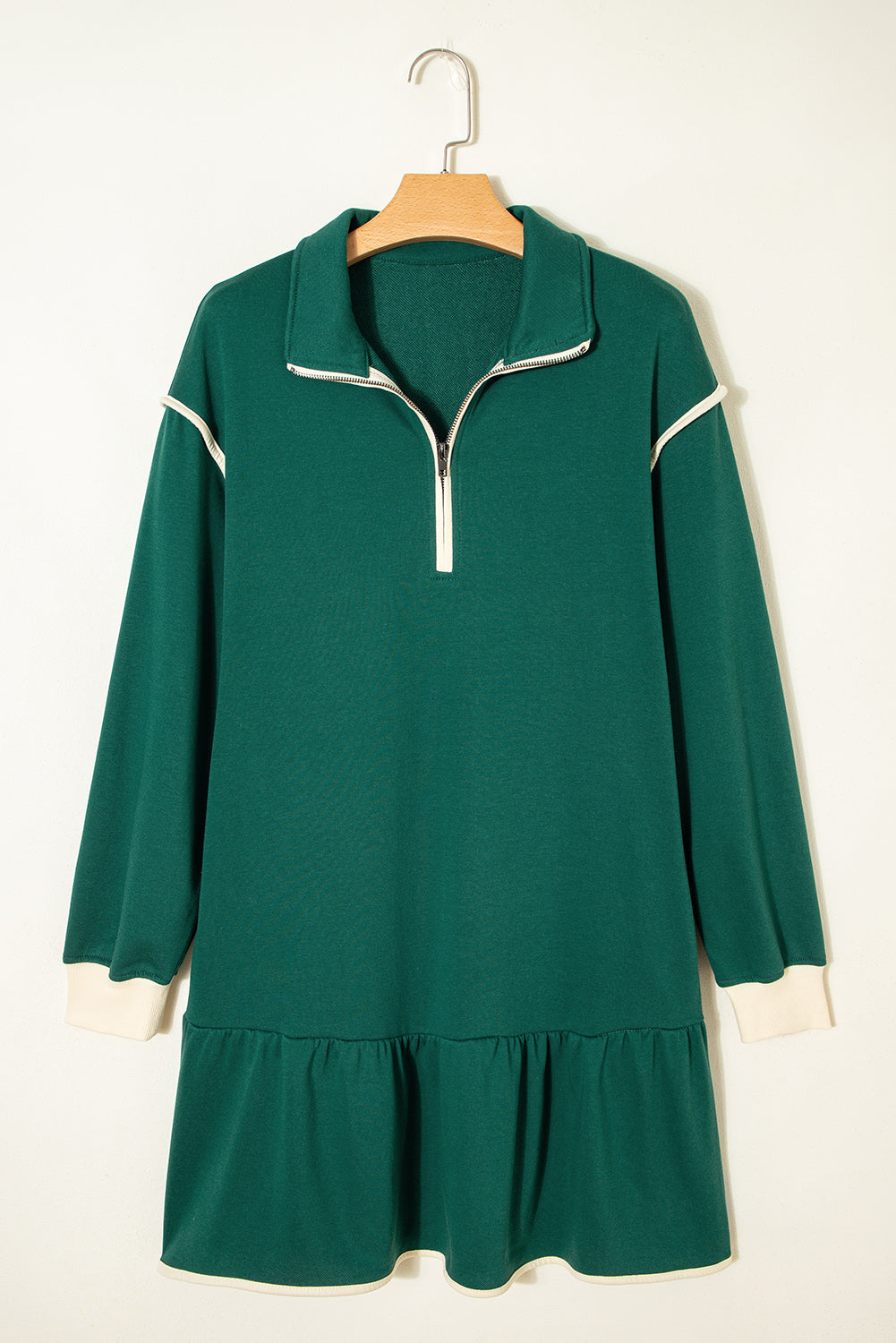 Green long sleeve dress with white zip collar, ruffled hem, and white trim accents
