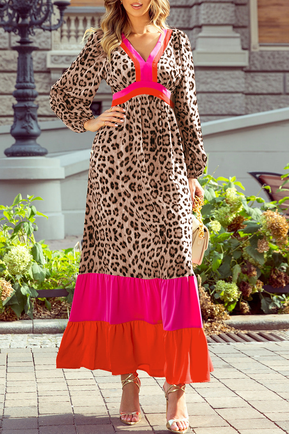 Woman wearing leopard print maxi dress with pink and red accents, outdoor setting