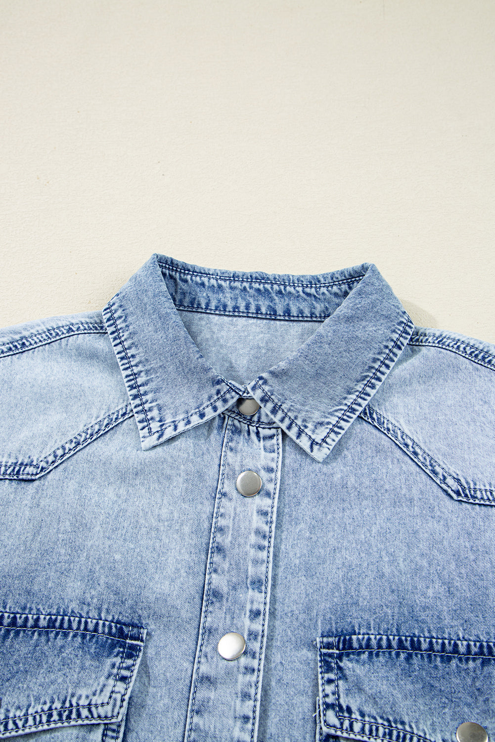 Light blue denim shirt with metal snap buttons and front chest pockets